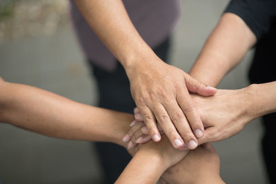Close-up of friends stacking hands