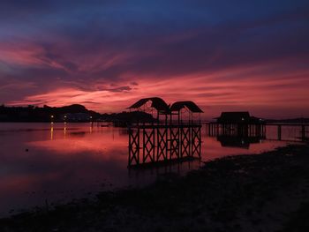 Scenic view of lake against romantic sky at sunset