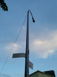 Low angle view of street light against blue sky