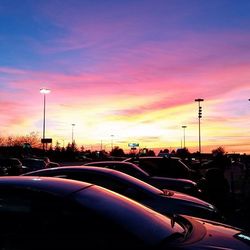 Cars on road at sunset