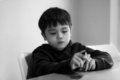 Portrait of boy sitting at home