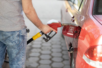 Midsection of man opening car