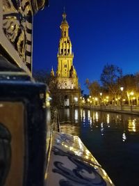 Reflection of illuminated building in water at night