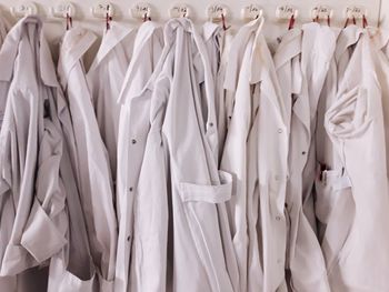Full frame shot of lab coats hanging at laboratory