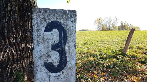 Close-up of old wooden post on field