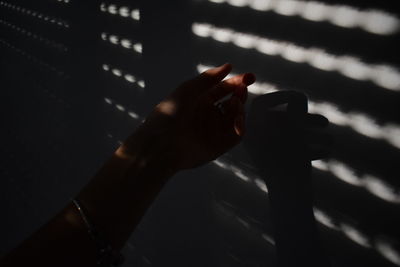 Close-up of hand holding shadow
