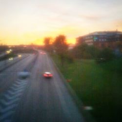 Cars on road at sunset