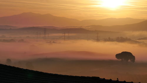 Sunrise in foggy landscape in tuscany