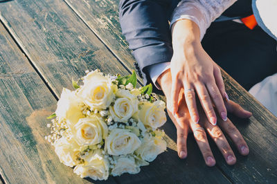 High angle view of people holding bouquet