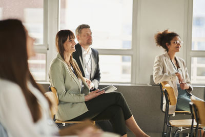 Entrepreneurs attending training class in conference centre at office