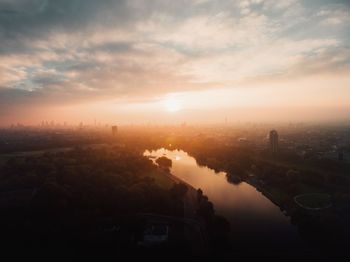 Aerial view of cityscape against sky during sunset