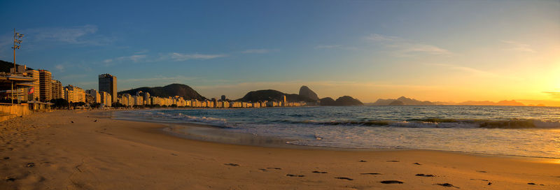 Scenic view of beach against sky during sunset