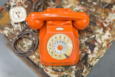 Antique vintage analog orange phone, communication concept theme.