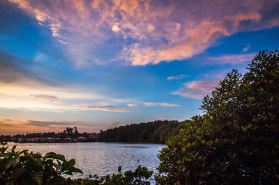 Scenic view of lake against sky at sunset