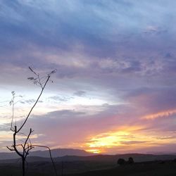 Scenic view of silhouette landscape against sky at sunset