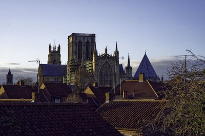 Buildings in city against clear sky