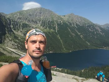 Portrait of young man with mountains in background