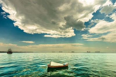 Boat moored in sea against sky