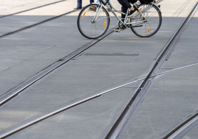 Low section of person riding bicycle on road