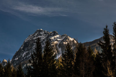 Low angle view of snowcapped mountain against sky