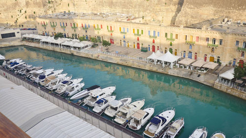 High angle view of boats in canal by buildings in city