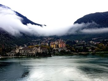 River amidst buildings in city against sky