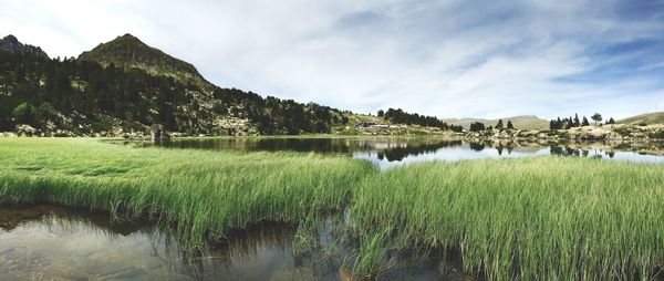 Idyllic shot of lake by mountain against sky