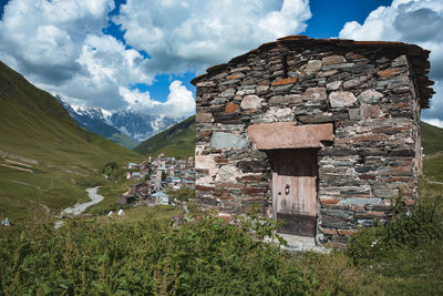 Panoramic shot of building and mountains against sky