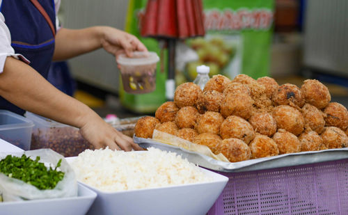 Midsection of man preparing food