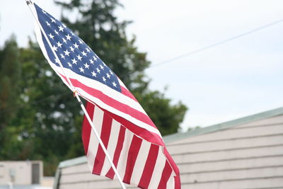 American flag against sky on fourth of july parade