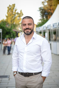 Portrait of smiling man standing on street