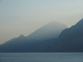 Scenic view of silhouette mountains against sky during sunset