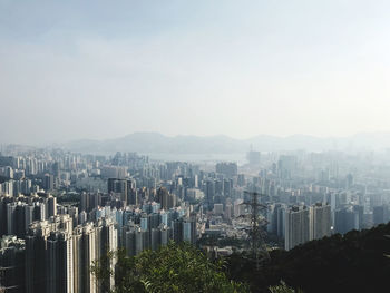 Aerial view of buildings in city against clear sky