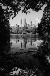 Scenic view of lake by buildings against sky