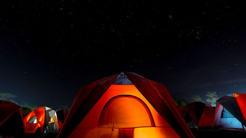 The orange tent under night sky and stars. location place phu kra dueng national park of thailand.