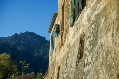 Low angle view of building against clear blue sky