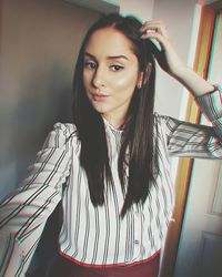 Portrait of smiling young woman at home