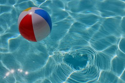 High angle view of ball floating on swimming pool