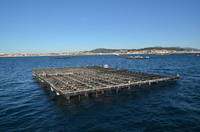 Aerial view of sea against clear blue sky