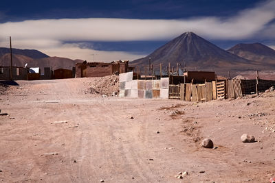 Houses on field against sky