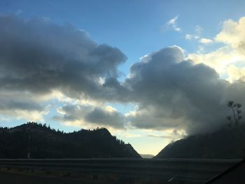 Scenic view of mountains against cloudy sky