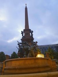 Low angle view of statue against sky in city