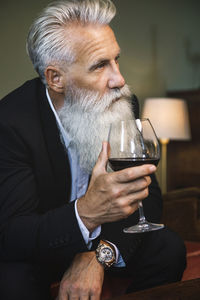 Portrait of senior man drinking glass