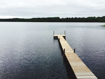 Pier over lake against sky