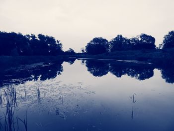 Scenic view of lake against sky during winter