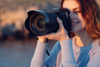 Portrait of woman photographing