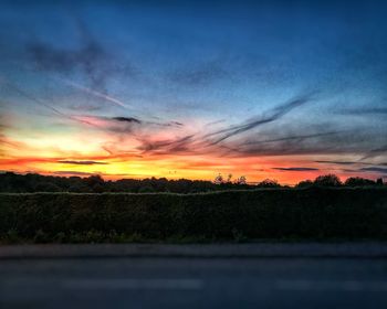 Scenic view of silhouette landscape against sky at sunset