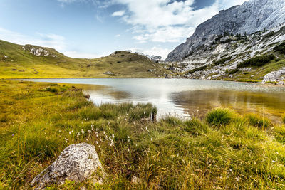 Scenic view of lake and mountains against sky