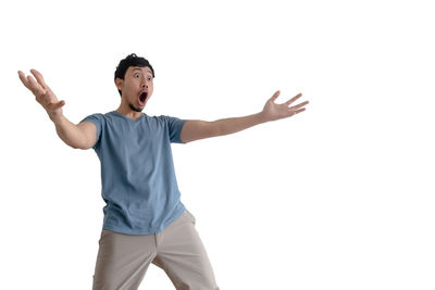 Young man standing against white background