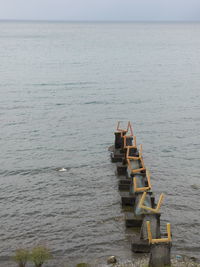 Pier on sea against clear sky